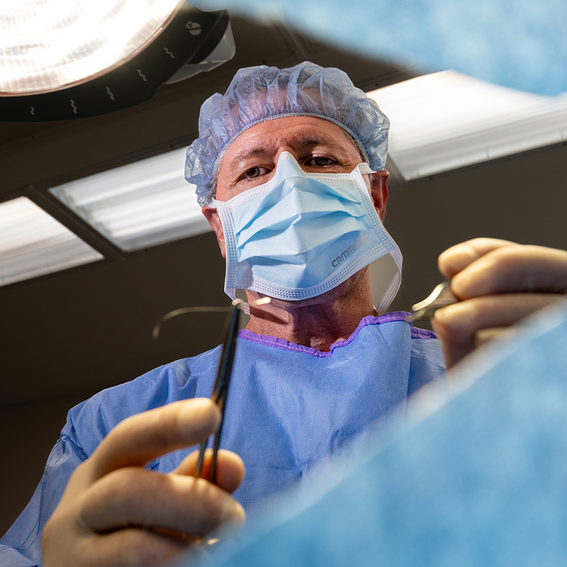 Dr. Johns holding a suture