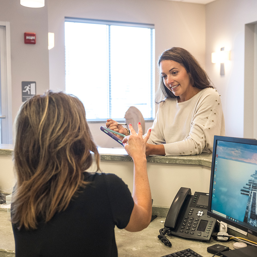 Receptionist with a patient